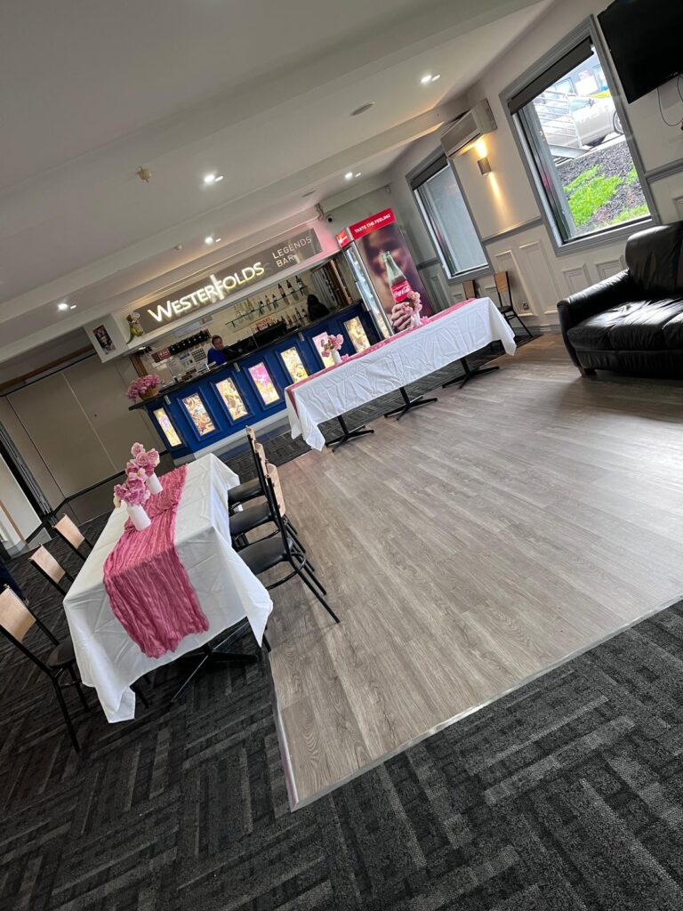Bright and modern function room decorated with a pink balloon installation for a baby shower